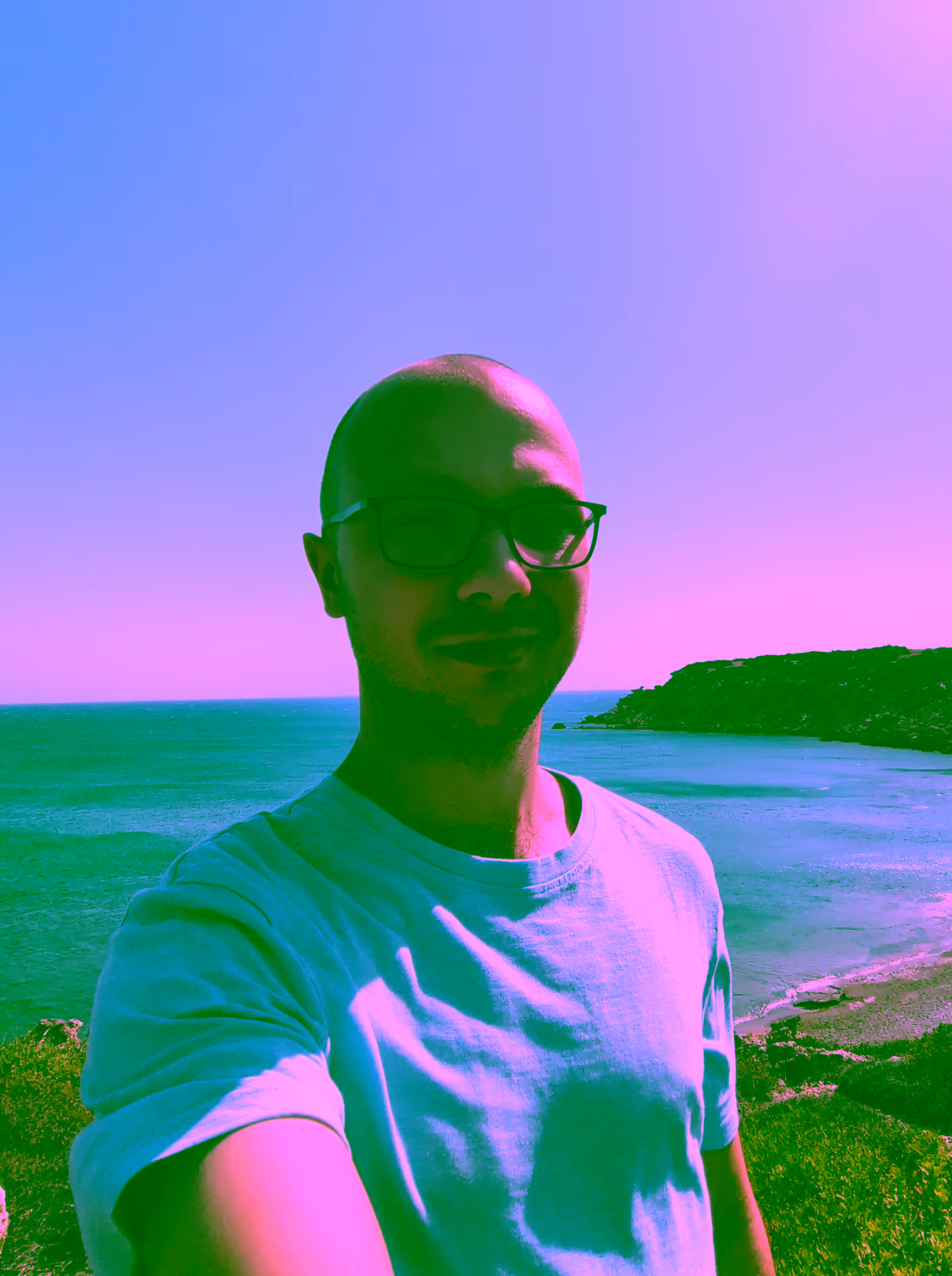 David standing above a cliff beach in Greece, Rhodos
